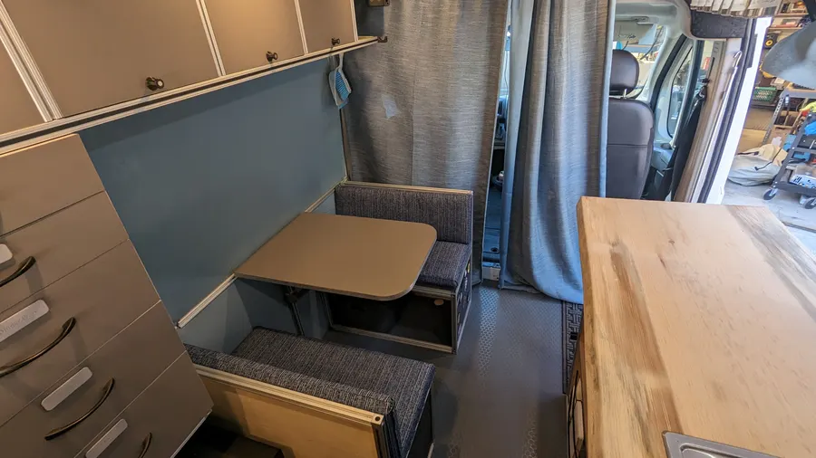 Convertible dinette with bench seating and drawer storage — Big Bear Camper Vans build
