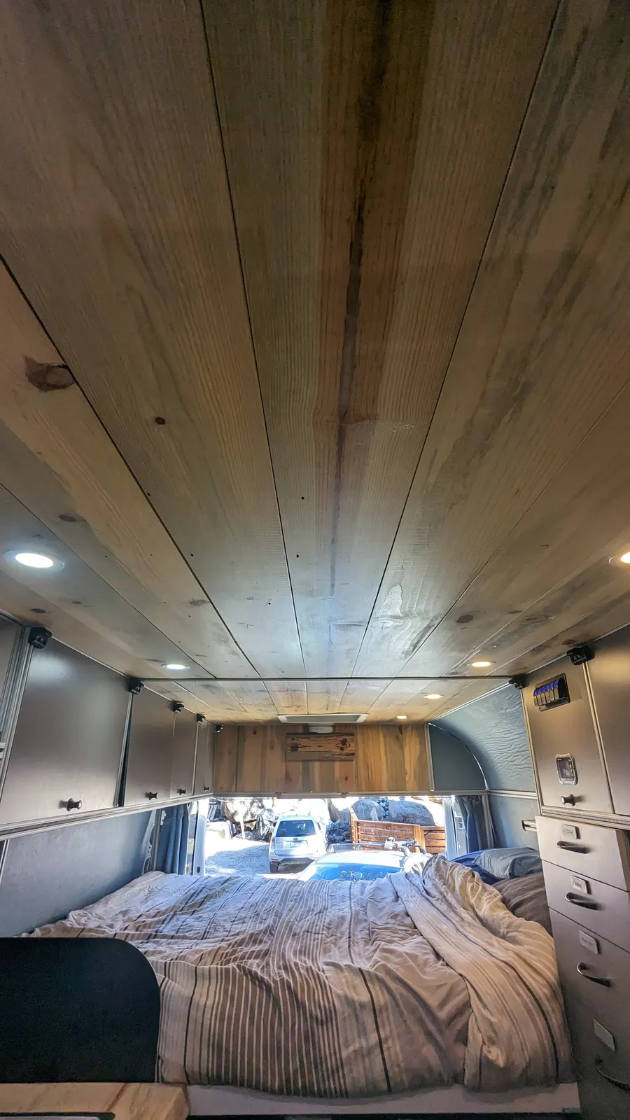 Cedar plank ceiling running the length of the build — Big Bear Camper Vans build