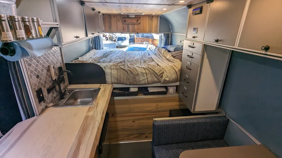 Galley, dinette, and sleeping platform in one ProMaster build — Big Bear Camper Vans build